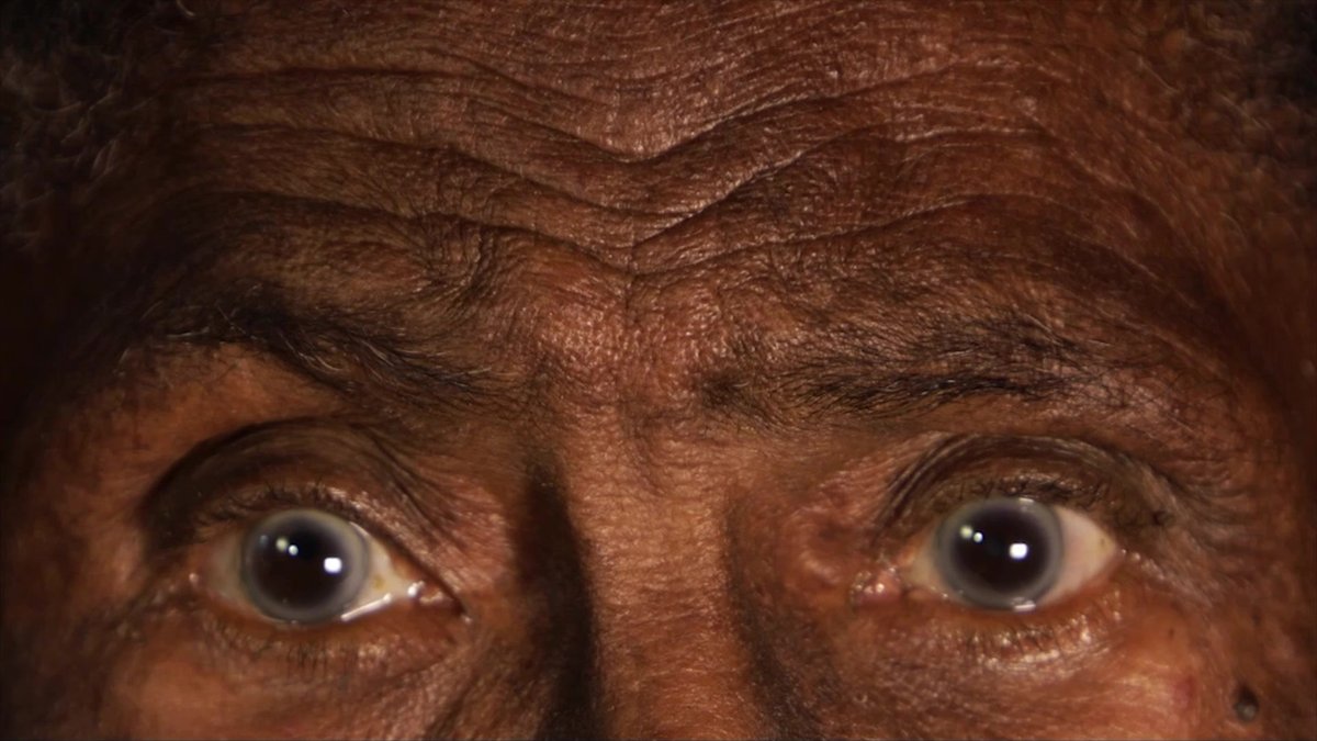 Close-up of an elderly face looking at the camera